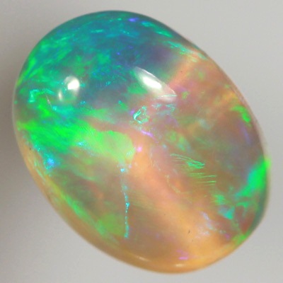 SOLID CRYSTAL OPAL Rolling flashes of green and turquoise with a purple hue